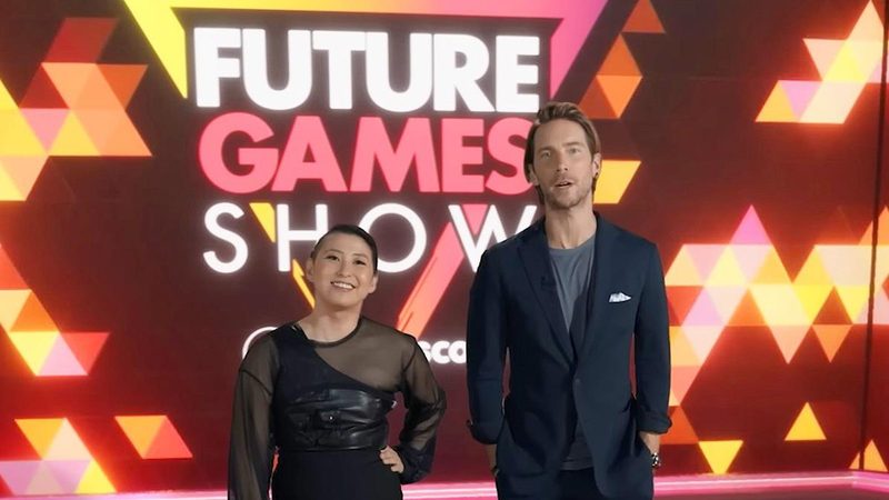 The Future Games Show presenters on the show set in front of the branded backdrop.
